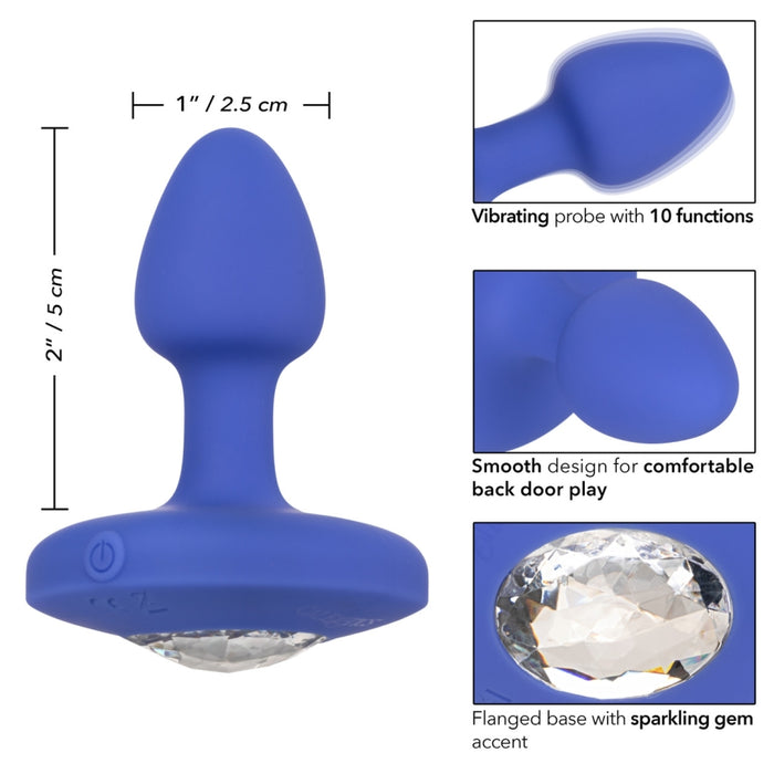 The Cheeky Gems Small Rechargeable Vibrating Butt Plug in blue silicone features 10 vibration functions, a smooth design, and a jeweled flanged base. Perfect for backdoor play; measures 2 inches tall by 1 inch wide.
