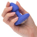 A manicured hand holds the Cheeky Gems Small Rechargeable Vibrating Butt Plug in blue, featuring a gem-like base—ideal for backdoor play—against a white background.