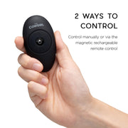 A hand holds a black oval remote labeled "The Cowgirl." Text reads: "Control The Cowgirl Saddle Sex Machine with Vibration, Thrusting & Rocking manually or via the magnetic rechargeable remote for seamless, hands-free pleasure.
