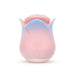 The Kissing Rose Vibrator with Tongue and Lips, in pink and blue body-safe silicone, features a rosebud shape with two circular front buttons and a petal-like top, displayed against a white background.