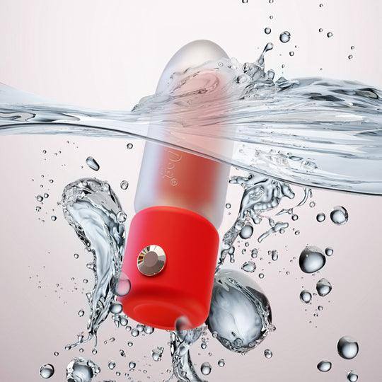Red and clear lipstick vibrator, waterproof, submerged in splashing water.