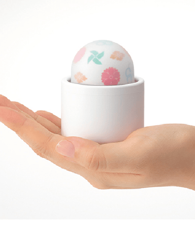 Tenga Vibrator Tenga Iroha Temari KAZE Egg Shaped Clitoral Vibrator held in a woman's palm